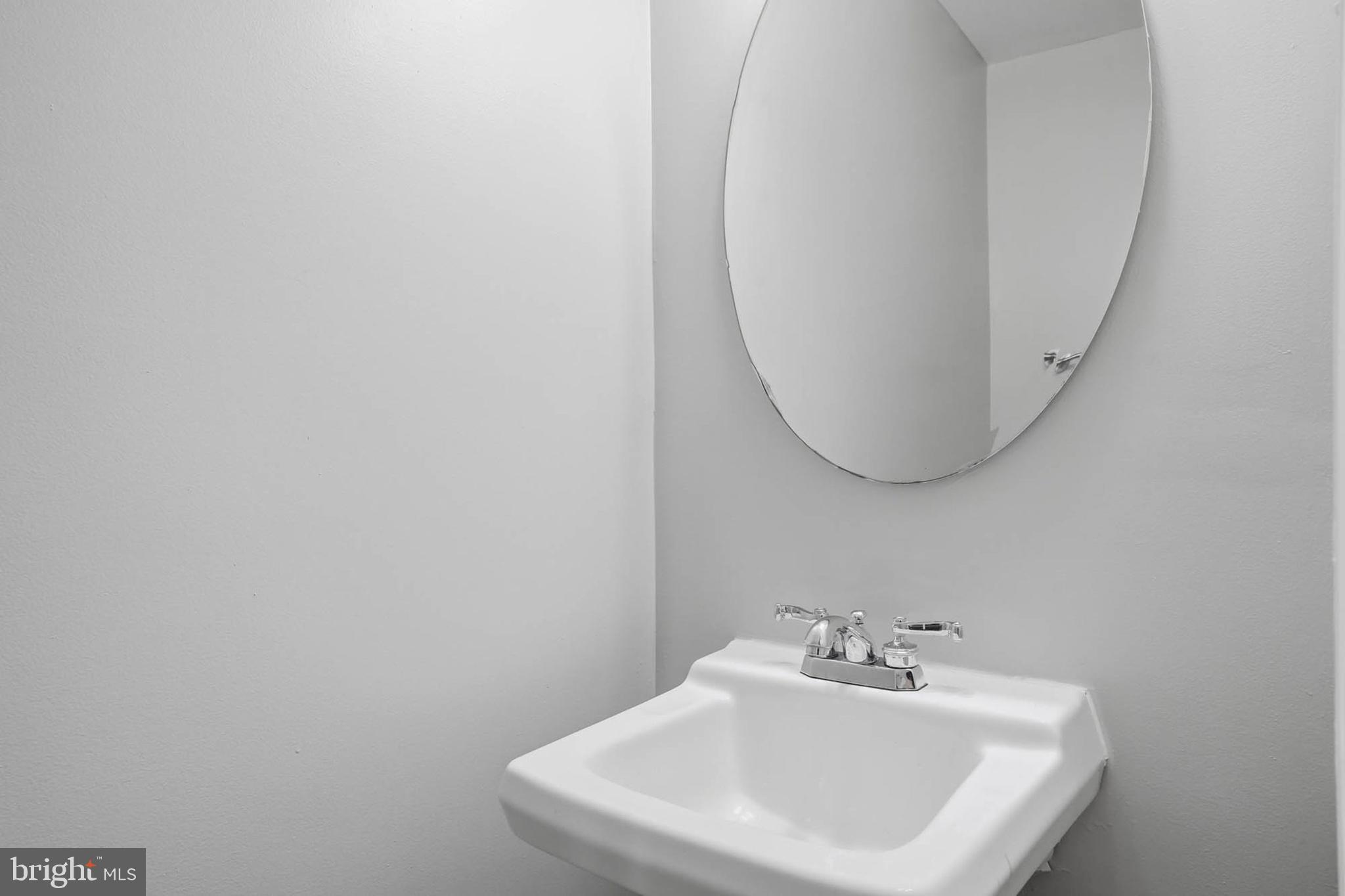 9931 Tuscarora Road Randallstown, MD 21133 - Photo 26 of 30 a bathroom with a sink and a mirror