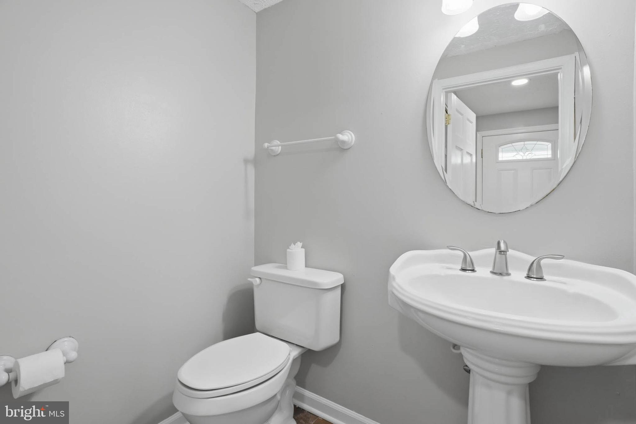 9931 Tuscarora Road Randallstown, MD 21133 - Photo 8 of 30 a bathroom with a toilet a sink and mirror