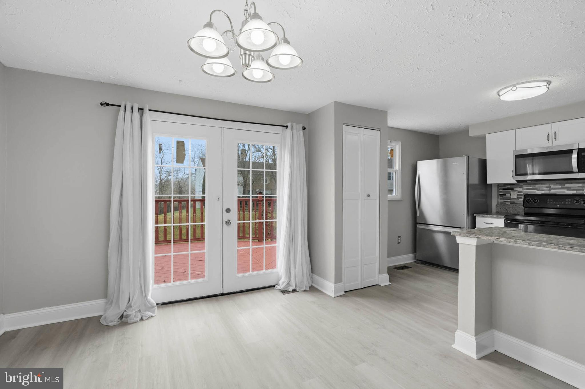 9931 Tuscarora Road Randallstown, MD 21133 - Photo 10 of 30 a view of a kitchen with a sink wooden cabinet and refrigerator