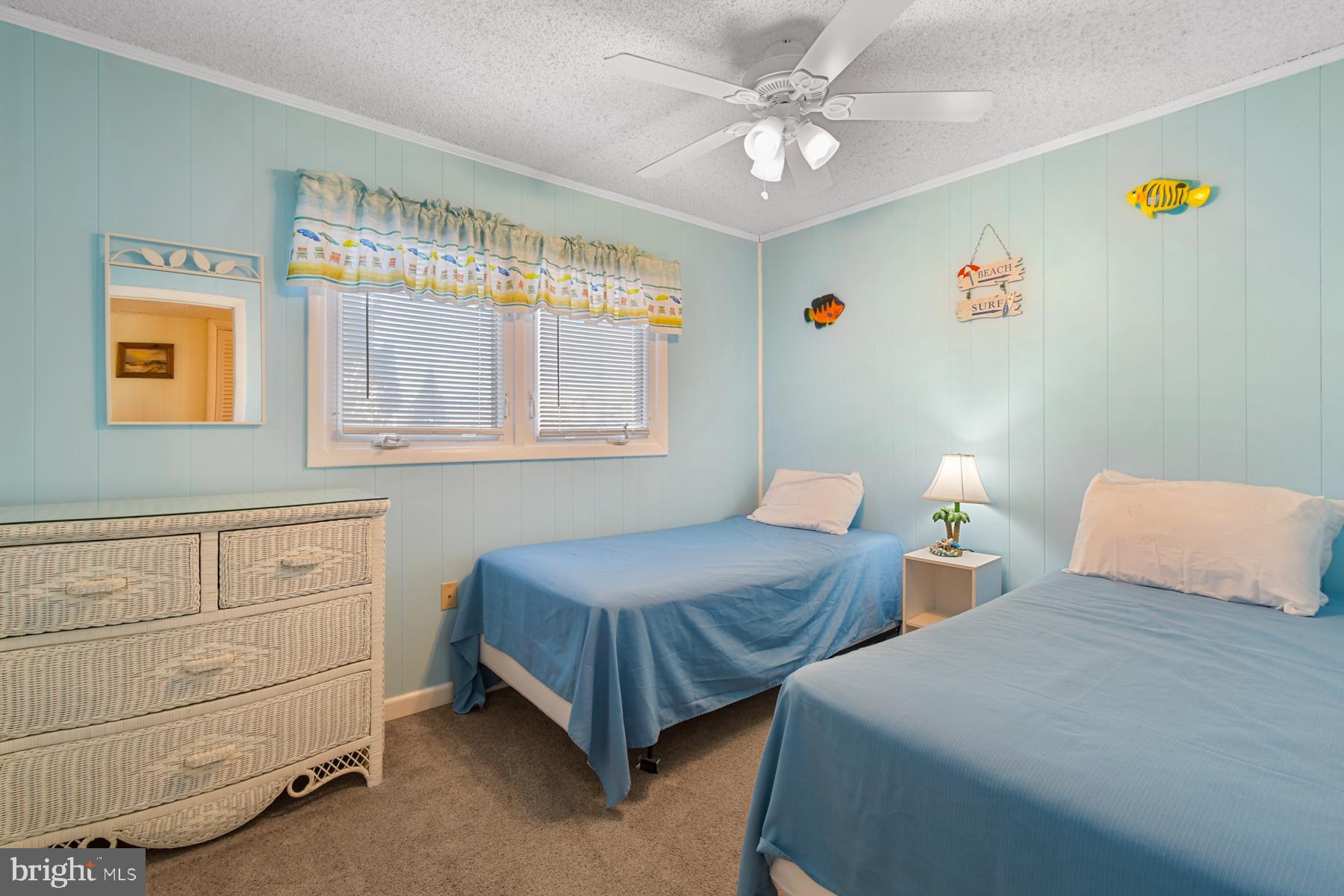 13 75th Street, Unit 1W Ocean City, MD 21842 - Photo 11 of 26 a bedroom with two beds and a window
