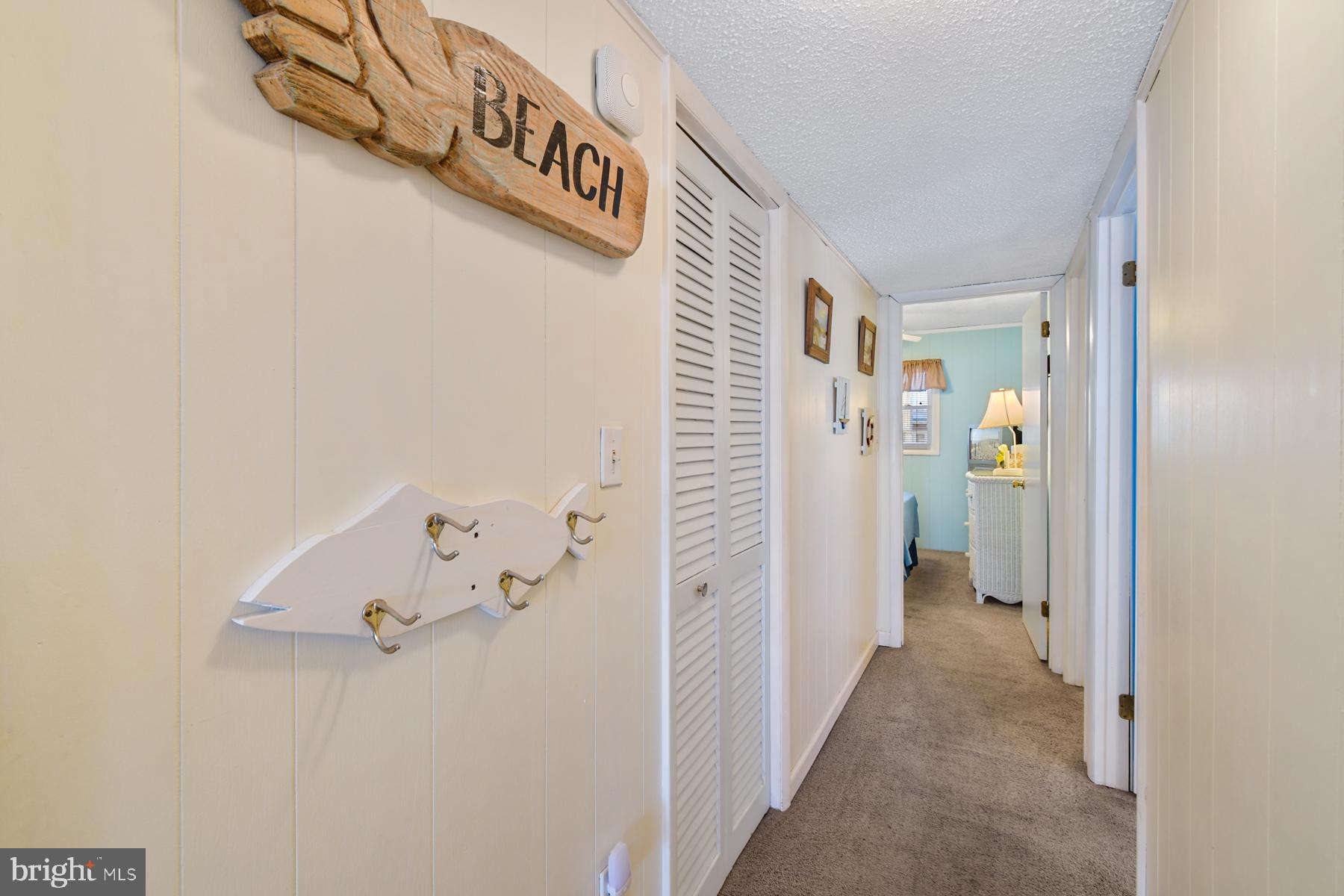13 75th Street, Unit 1W Ocean City, MD 21842 - Photo 13 of 26 a view of a hallway with closet