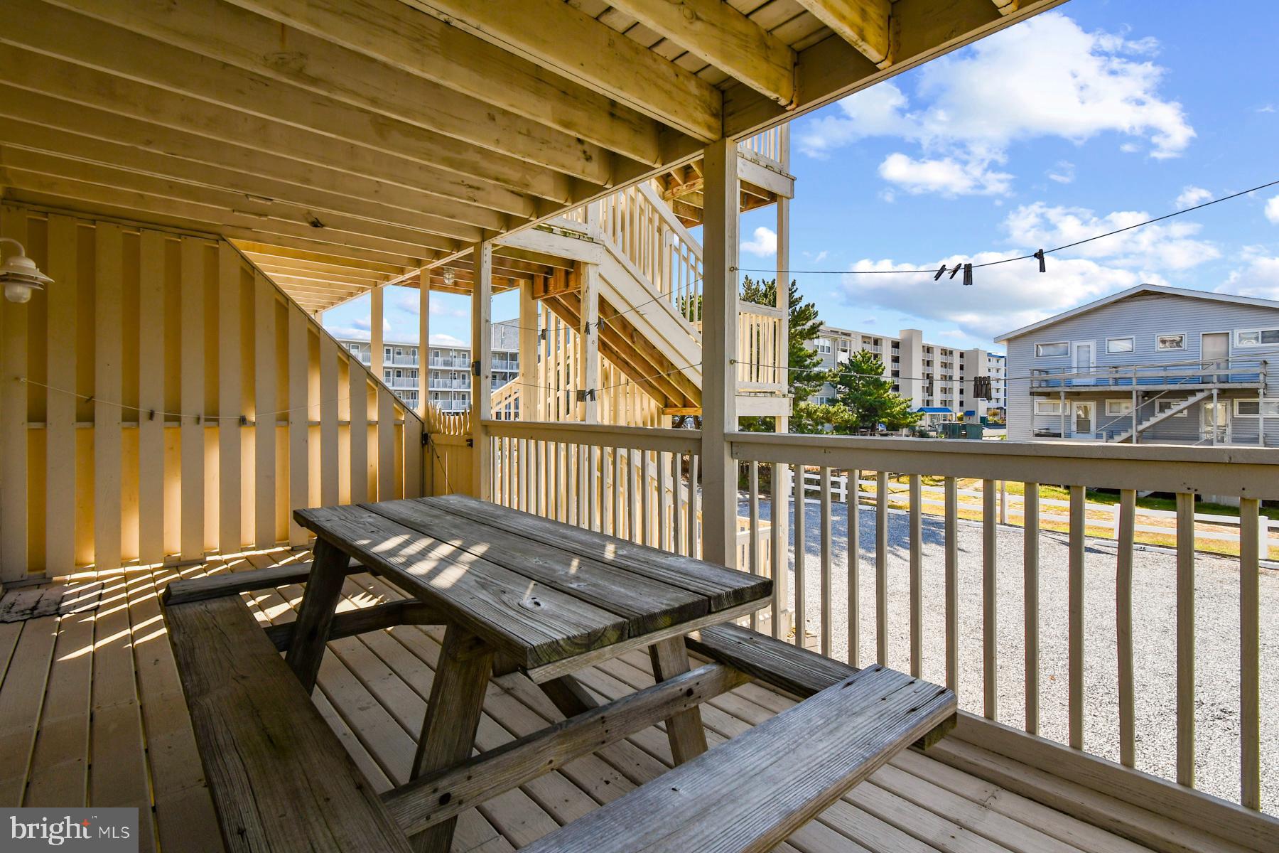13 75th Street, Unit 1W Ocean City, MD 21842 - Photo 17 of 26 a view of balcony with wooden floor and outdoor seating