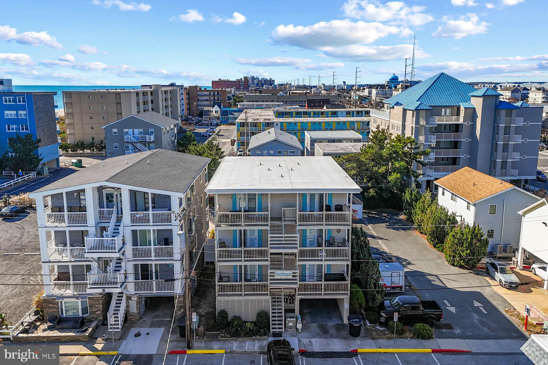 13 75th Street, Unit 1W Ocean City, MD 21842 - Photo 20 of 26 a front view of a multi story building with yard