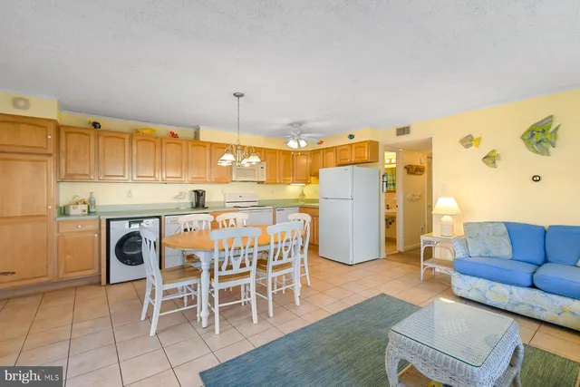 a kitchen with stainless steel appliances granite countertop a table and chairs