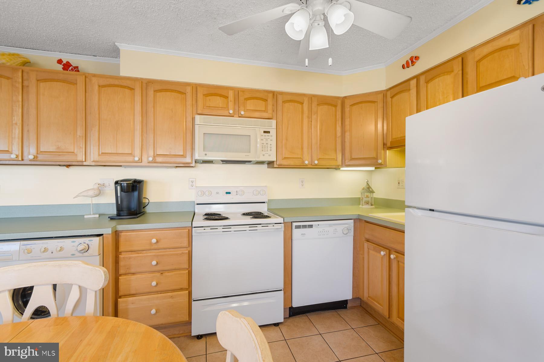 13 75th Street, Unit 1W Ocean City, MD 21842 - Photo 7 of 26 a kitchen with a refrigerator a stove a sink and cabinets