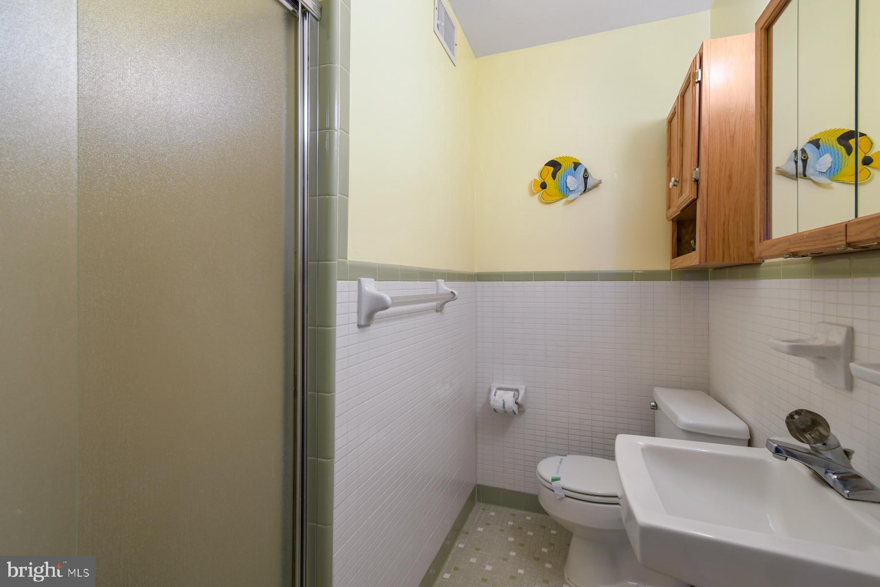 13 75th Street, Unit 1W Ocean City, MD 21842 - Photo 9 of 26 a bathroom with a toilet and a sink