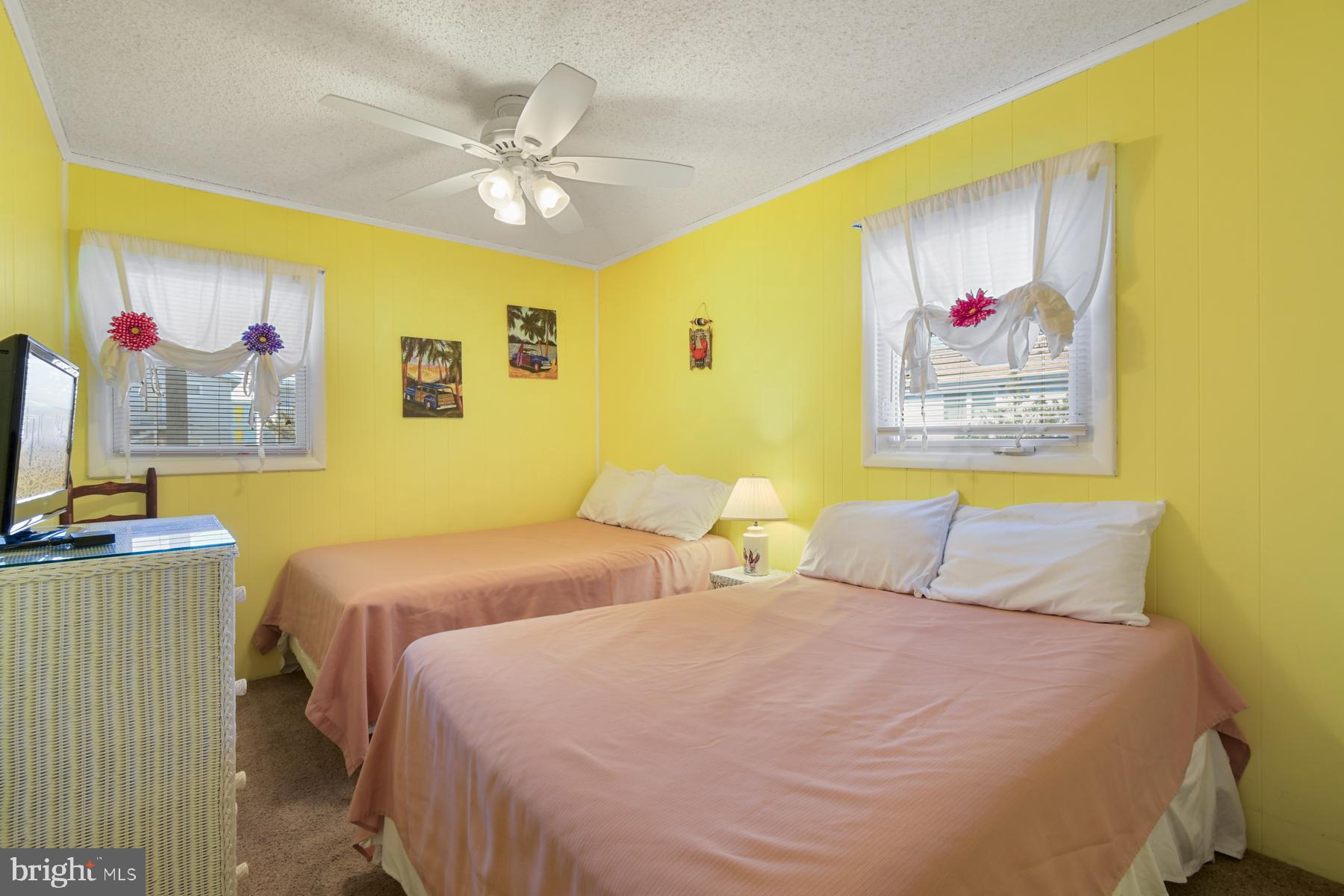13 75th Street, Unit 1W Ocean City, MD 21842 - Photo 10 of 26 a bedroom with a bed and a painting on the wall