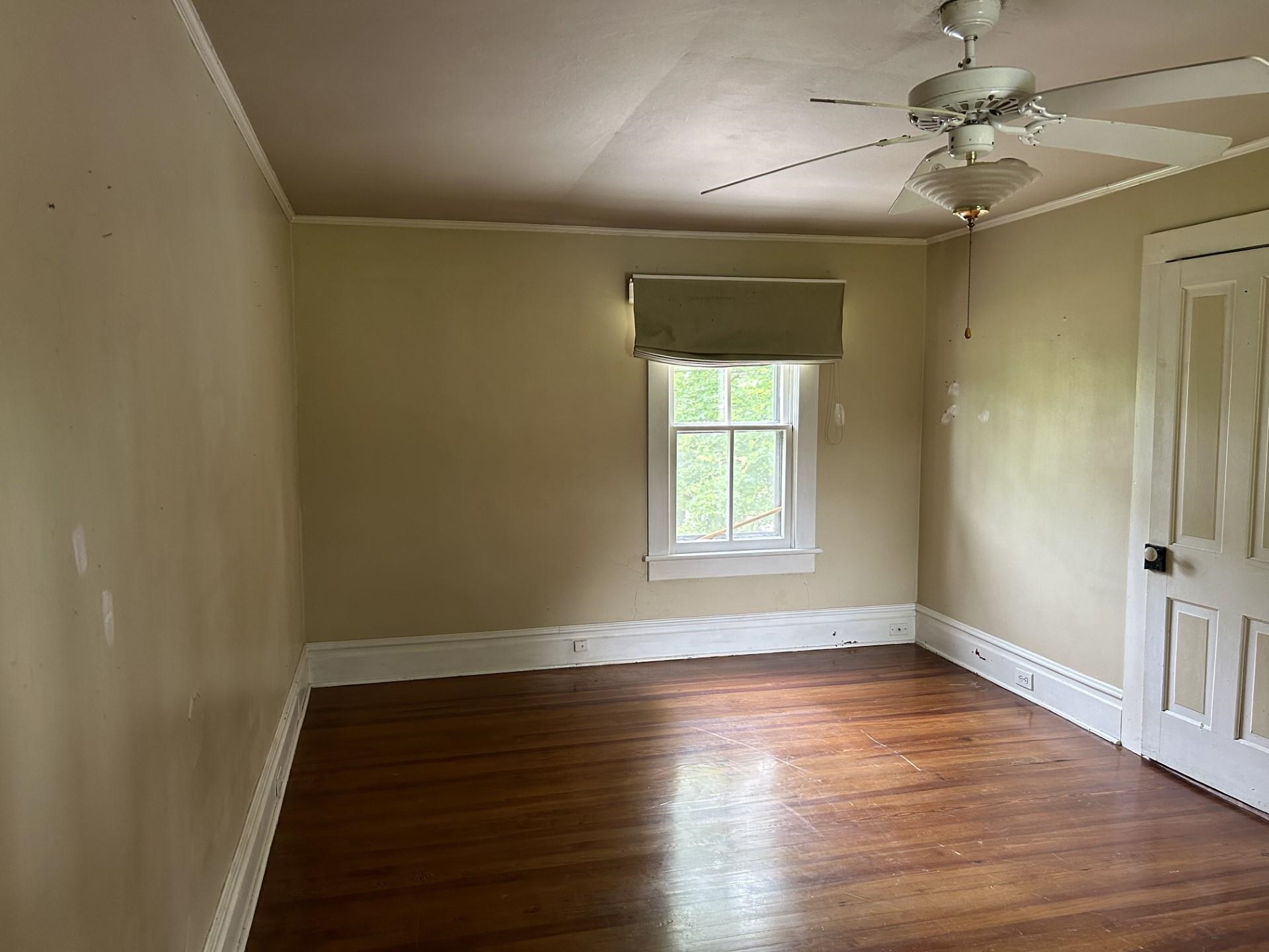 29 Tye River Turnpike Raphine, VA 24472 - Photo 13 of 17 an empty room with wooden floor fan and windows