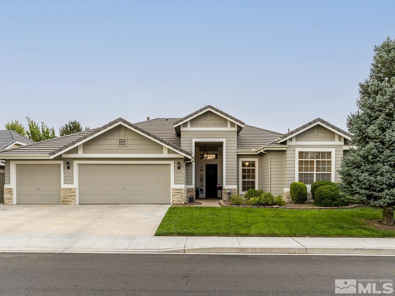 9684 Rolling Rock Way Reno, NV 89521 - Photo 1 of 34 a front view of a house with a garden