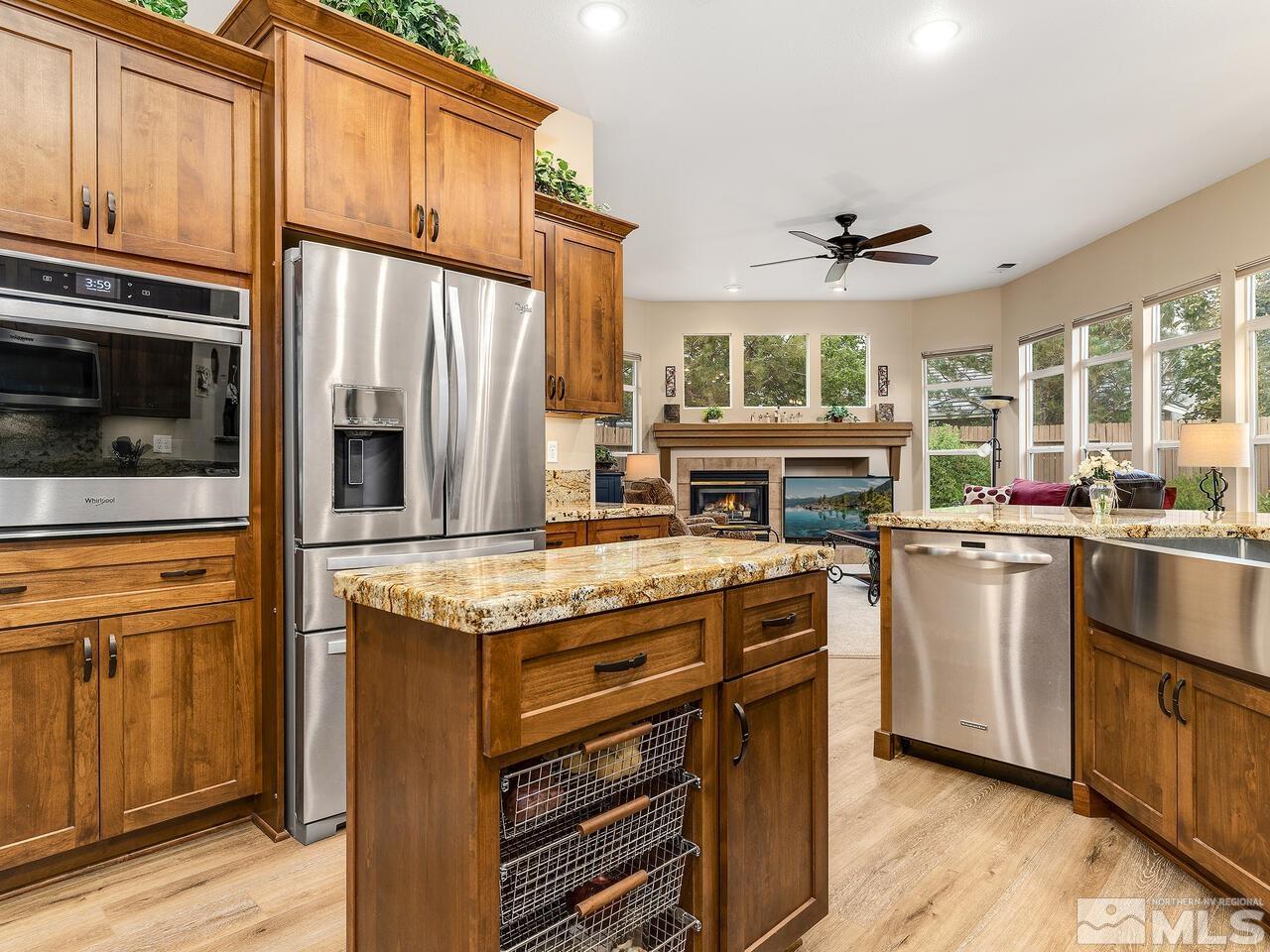 9684 Rolling Rock Way Reno, NV 89521 - Photo 13 of 34 a kitchen with stainless steel appliances granite countertop a stove and a refrigerator