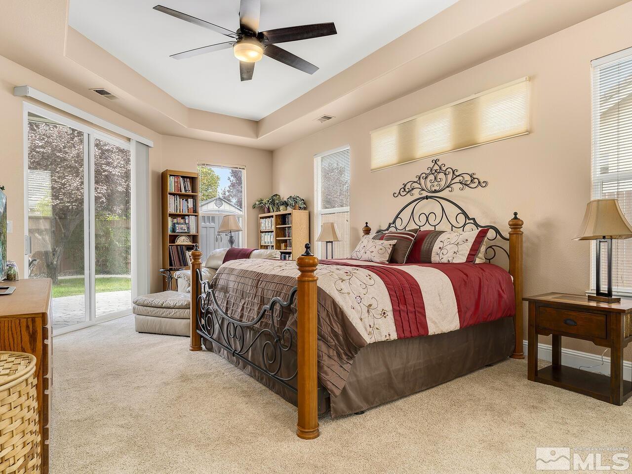 9684 Rolling Rock Way Reno, NV 89521 - Photo 18 of 34 a spacious bedroom with a bed and a chandelier