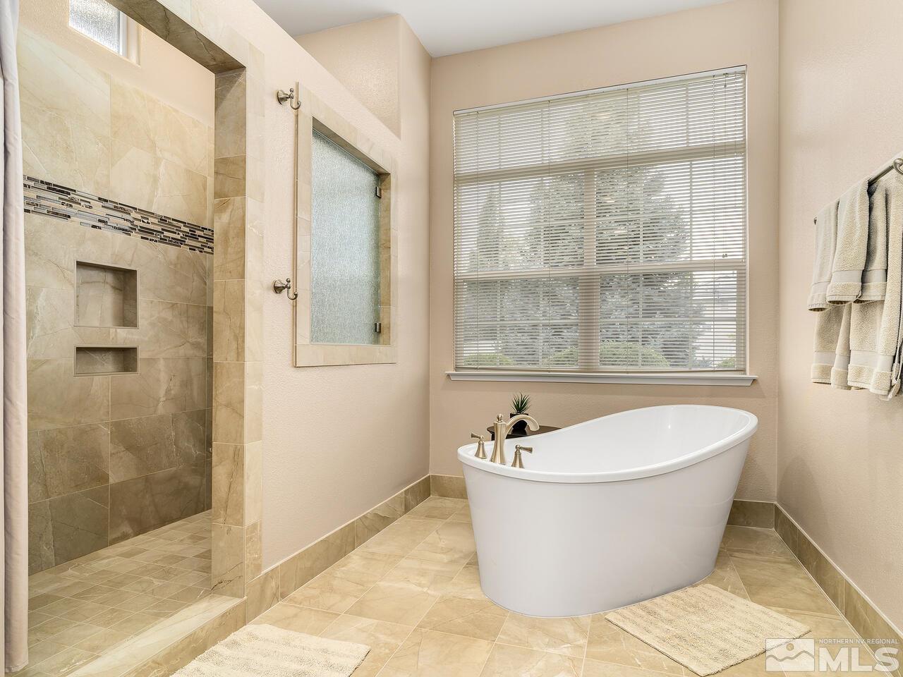 9684 Rolling Rock Way Reno, NV 89521 - Photo 21 of 34 a large tub sitting next to a shower