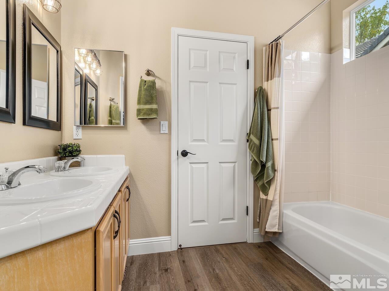 9684 Rolling Rock Way Reno, NV 89521 - Photo 24 of 34 a bathroom with a sink a mirror and a bathtub