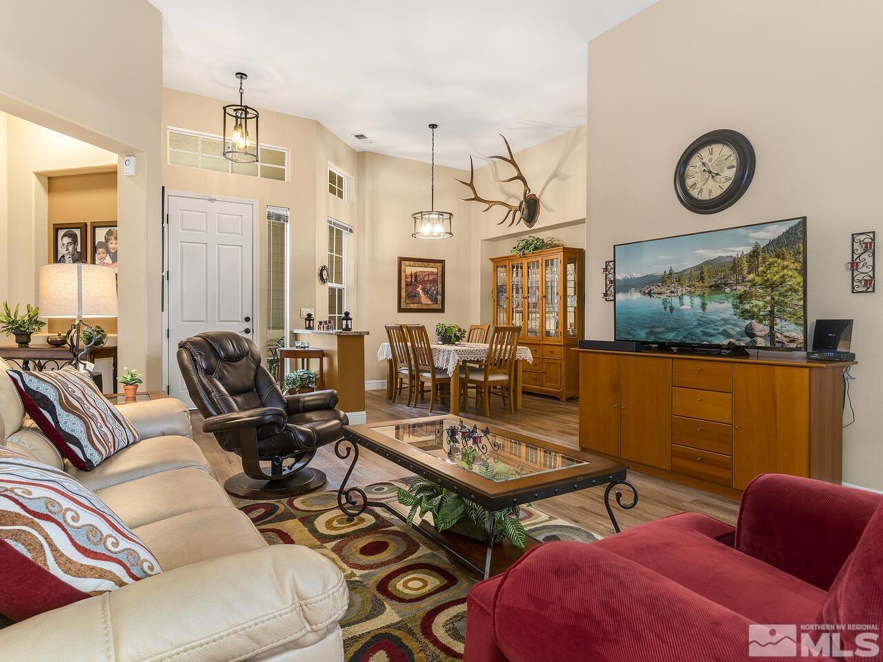 9684 Rolling Rock Way Reno, NV 89521 - Photo 5 of 34 a living room with furniture a rug and a wall painting
