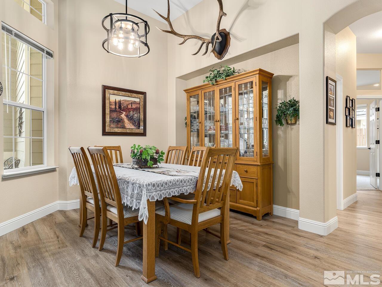 9684 Rolling Rock Way Reno, NV 89521 - Photo 6 of 34 a view of a dining room with furniture wooden floor and a chandelier