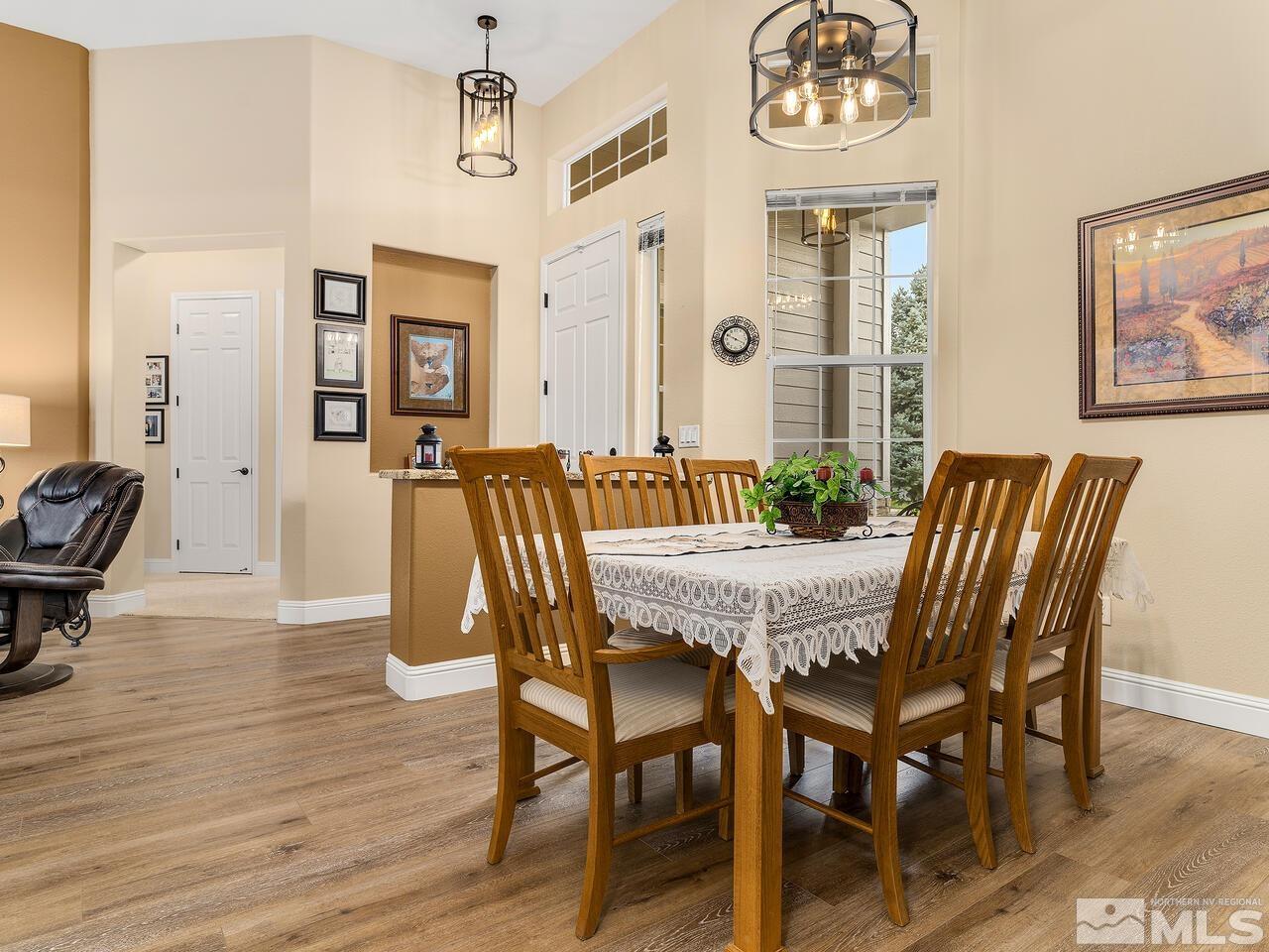 9684 Rolling Rock Way Reno, NV 89521 - Photo 7 of 34 a view of a dining room with furniture and wooden floor