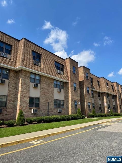 a view of a brick building next to a yard