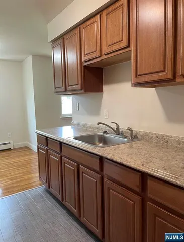 a kitchen with stainless steel appliances granite countertop a sink dishwasher stove and cabinets