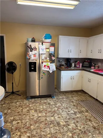 a kitchen with a sink a stove and a refrigerator