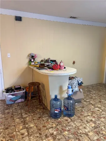 a room with a wooden floor and a sink