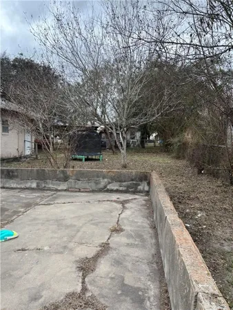 a view of a yard with wooden fence