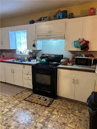a kitchen with a stove and cabinets