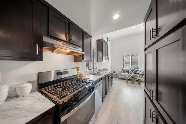 a kitchen with stainless steel appliances granite countertop a stove and a refrigerator