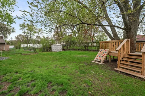 a picture of floor with a white fence and a painting on the wall