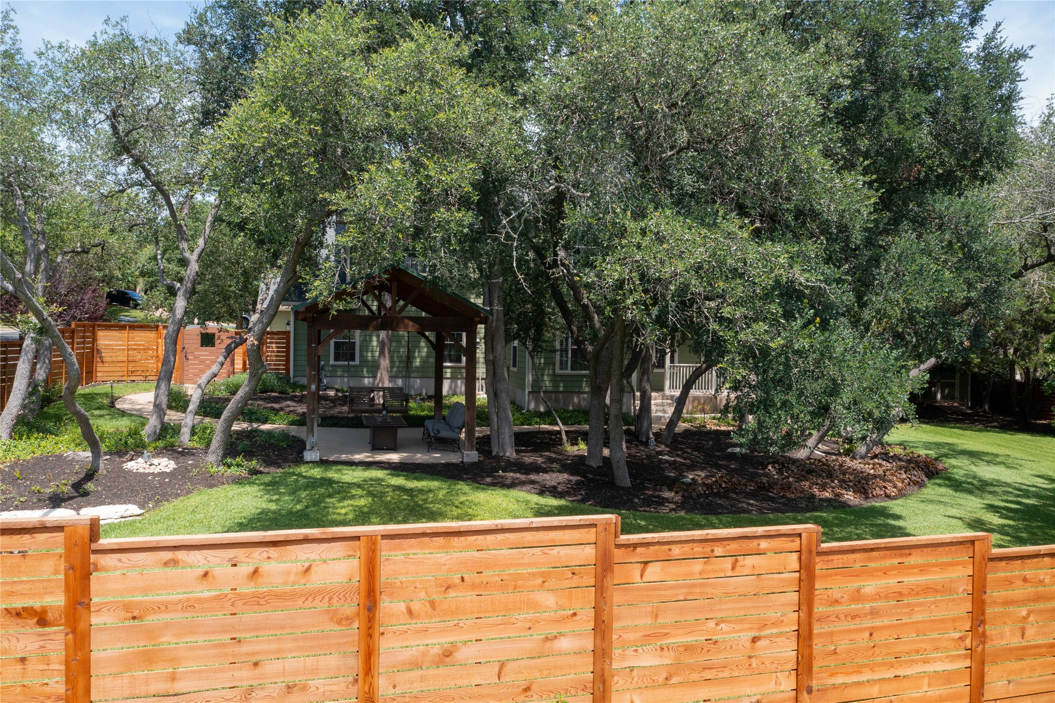 1204 Orlando Road Austin, TX 78733 - Photo 31 of 40 Mature trees shade a charming backyard oasis with a private gazebo and inviting fire pit.