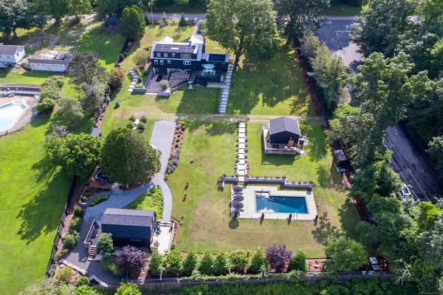 an aerial view of house with yard swimming pool and outdoor seating