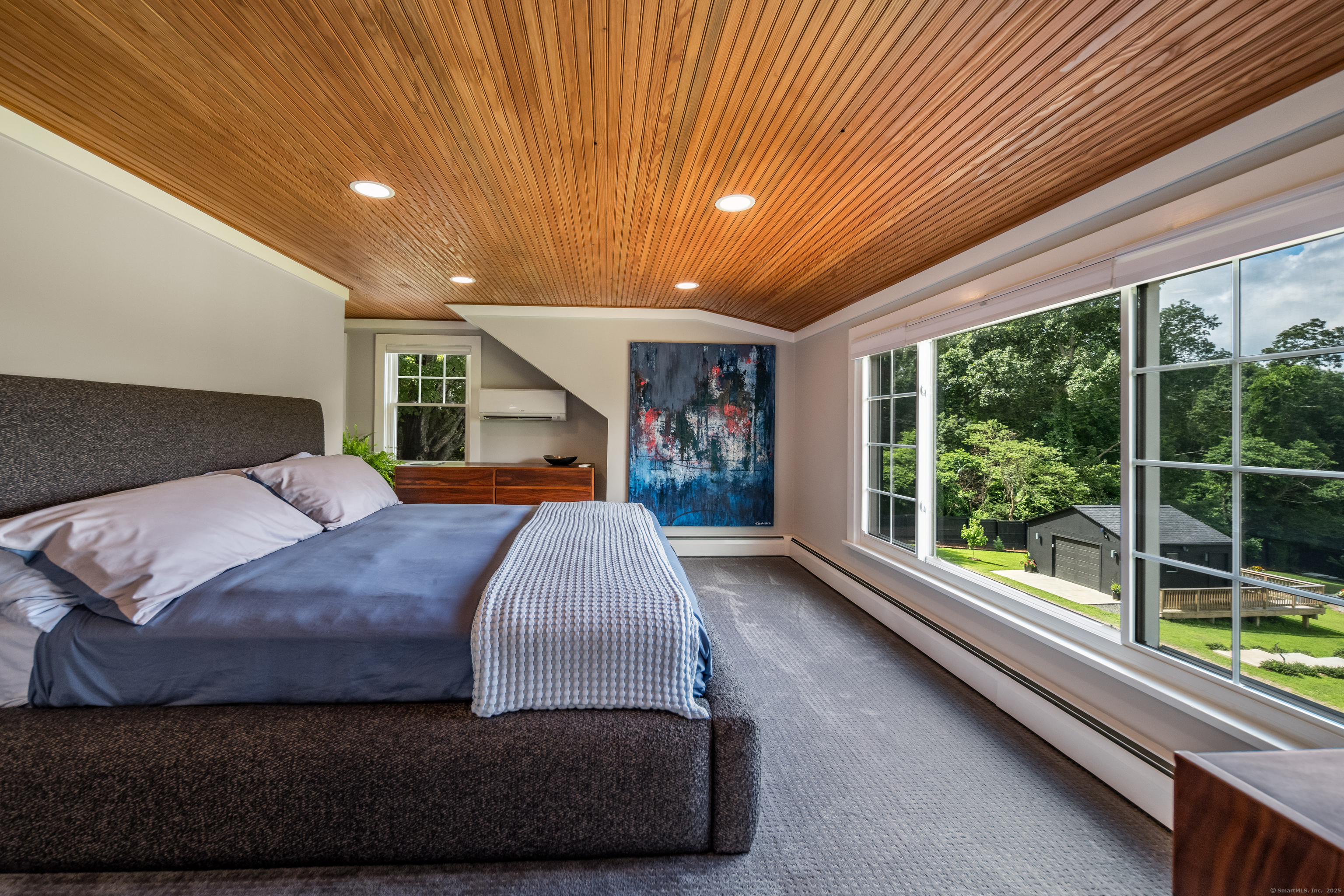 55 Bogel Road East Haddam, CT 06423 - Photo 13 of 39 a spacious bedroom with a large bed and a large window