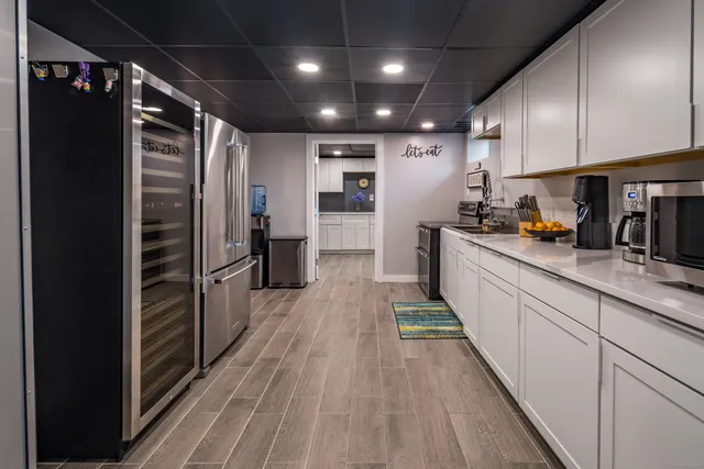 a kitchen with refrigerator and cabinets