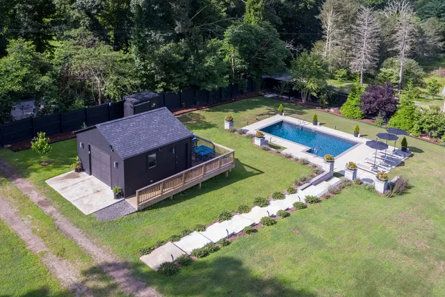 a view of a house with a yard and swimming pool