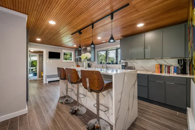 a dining room with furniture and a floor to ceiling window
