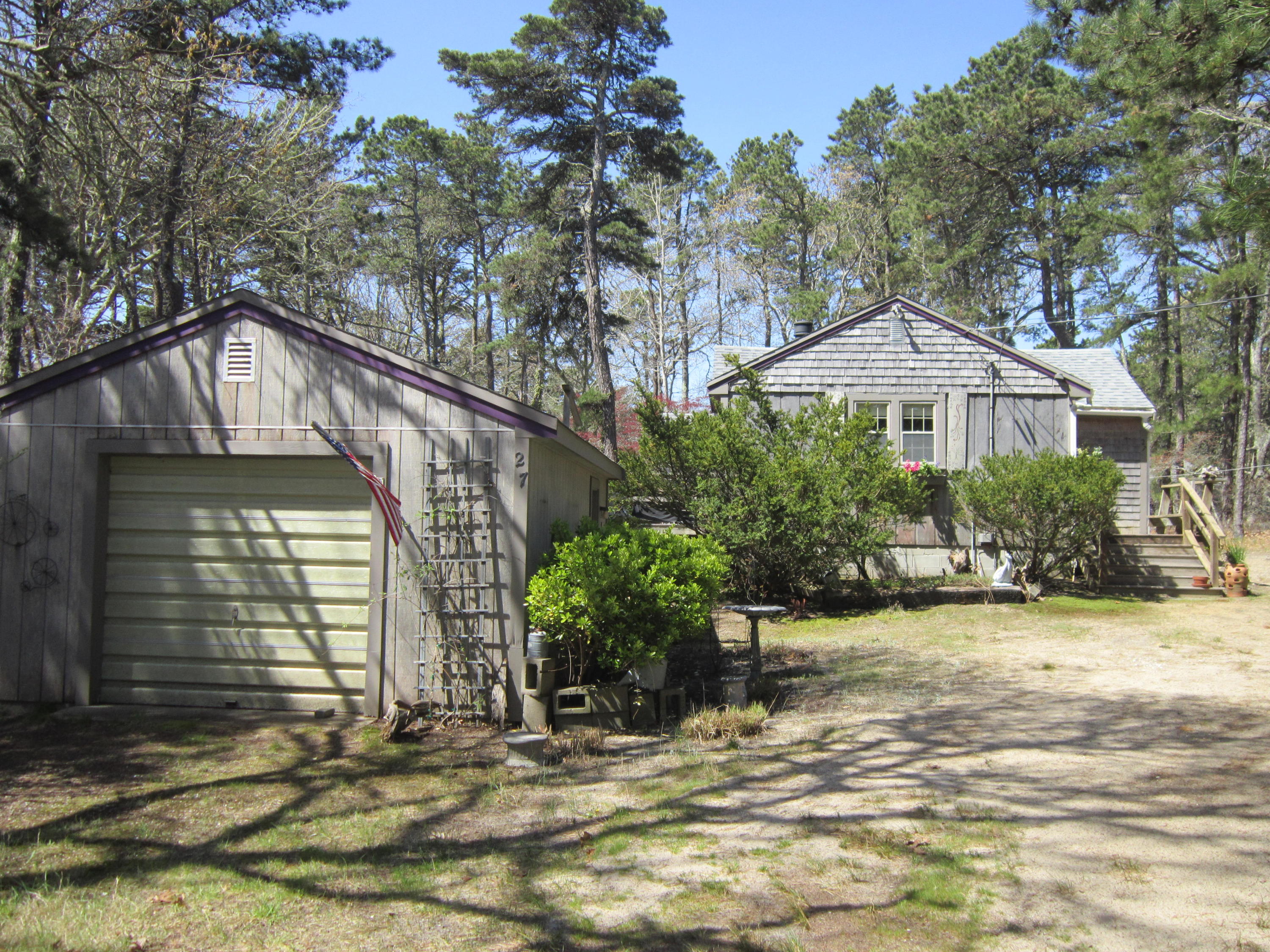 27 Bartlett Road Wellfleet, MA 02667 - Photo 1 of 32 a front view of a house with garden