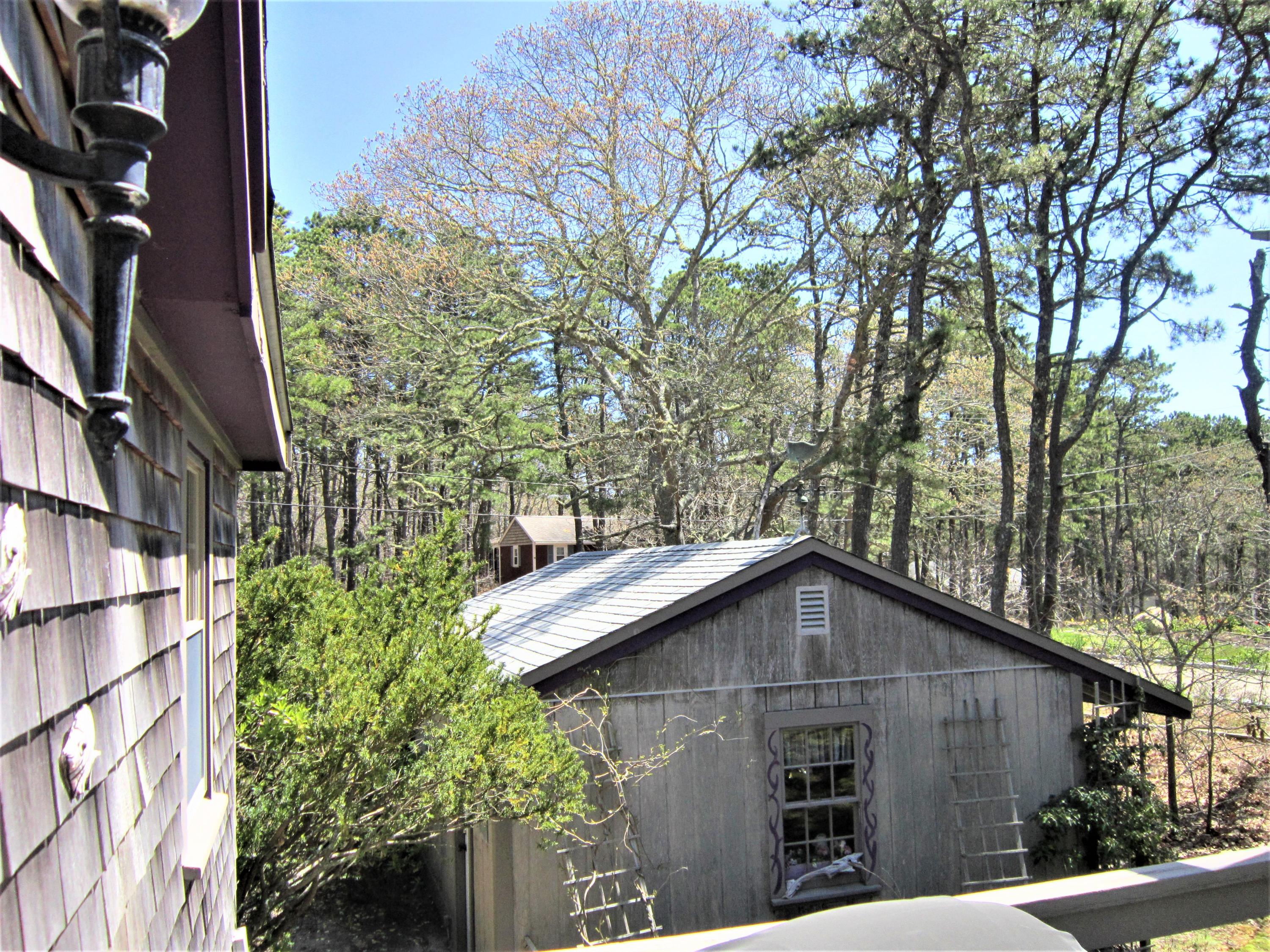 27 Bartlett Road Wellfleet, MA 02667 - Photo 30 of 32 a house with trees in the background