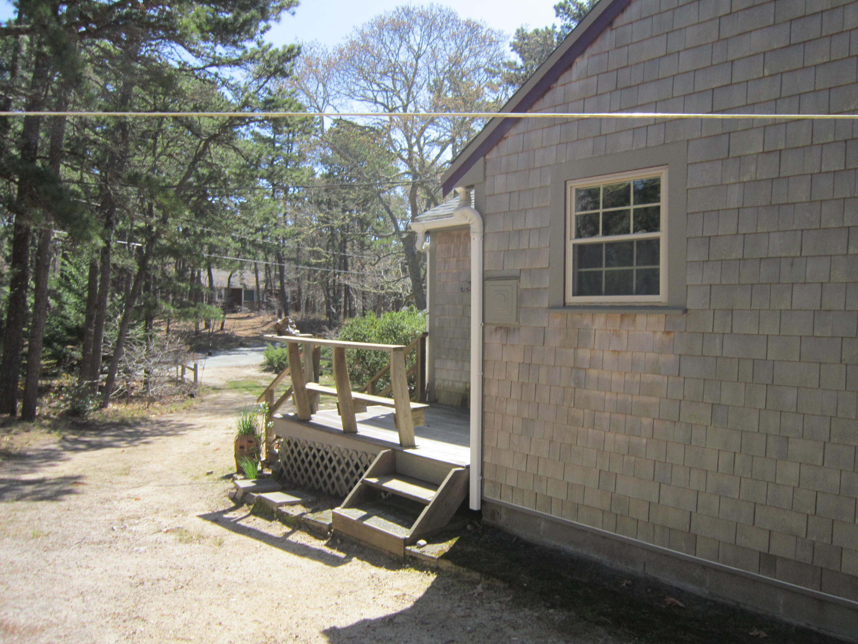 27 Bartlett Road Wellfleet, MA 02667 - Photo 5 of 32 a view of a patio with a table and chairs