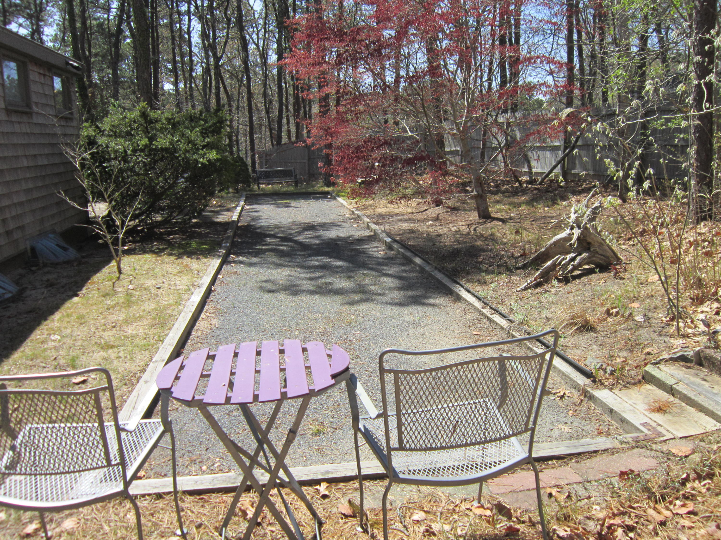 27 Bartlett Road Wellfleet, MA 02667 - Photo 7 of 32 a backyard of a house with table and chairs