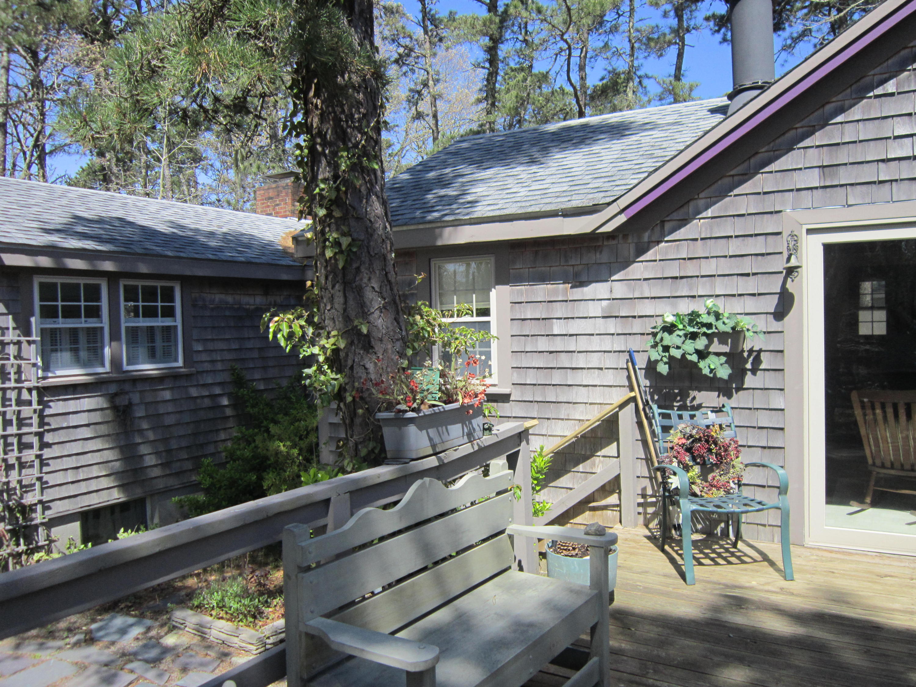 27 Bartlett Road Wellfleet, MA 02667 - Photo 9 of 32 a view of house with outdoor seating and trees in the background