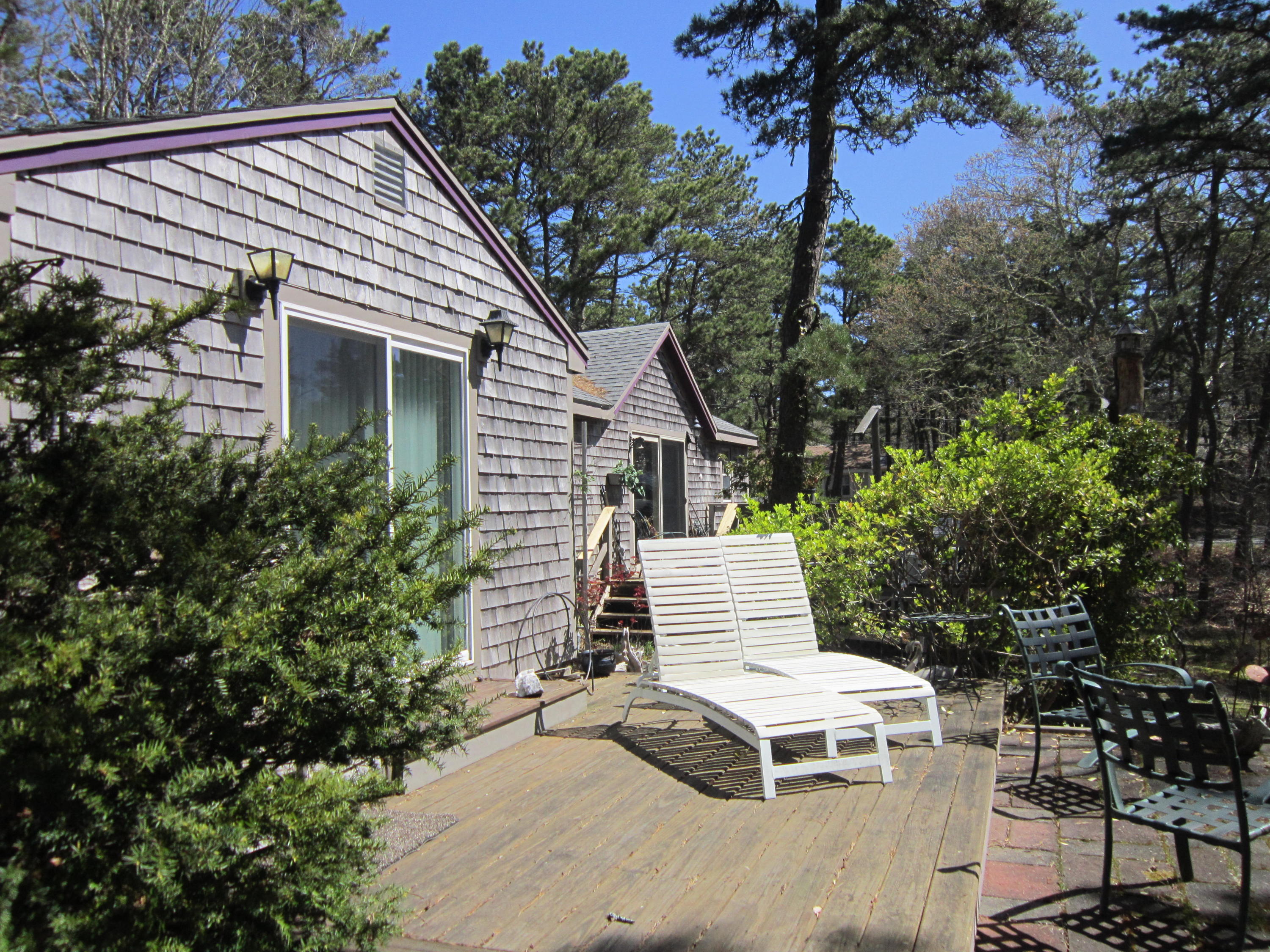 27 Bartlett Road Wellfleet, MA 02667 - Photo 10 of 32 a view of a patio with a table and chairs and potted plants