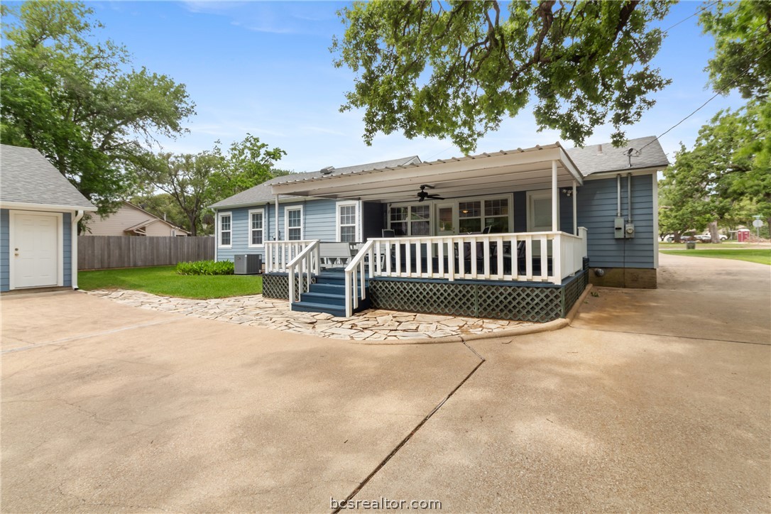 717 Inwood Drive Bryan, TX 77802 - Photo 39 of 48 View of the back. elevation with large, covered deck and expansive flat work to park in or out of the garage.