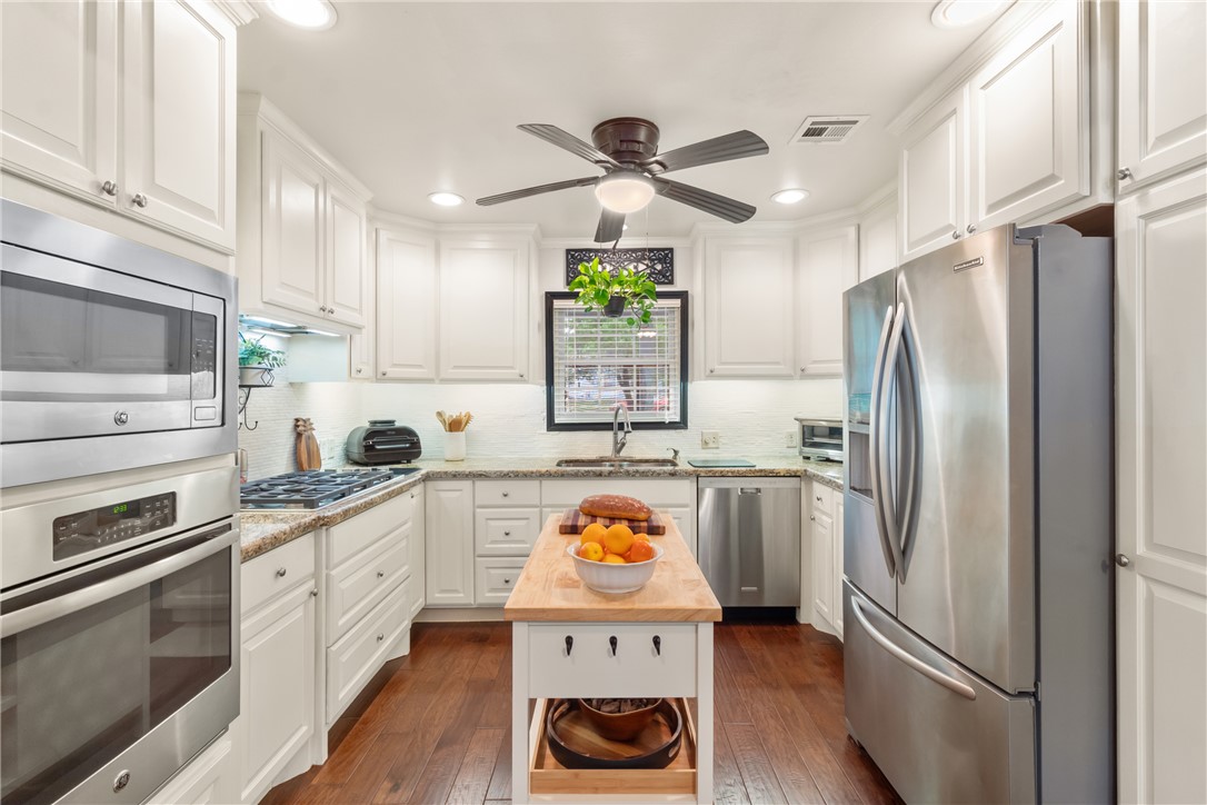 717 Inwood Drive Bryan, TX 77802 - Photo 5 of 48 Remodeled kitchen includes stainless appliances and granite counters. Island is included.