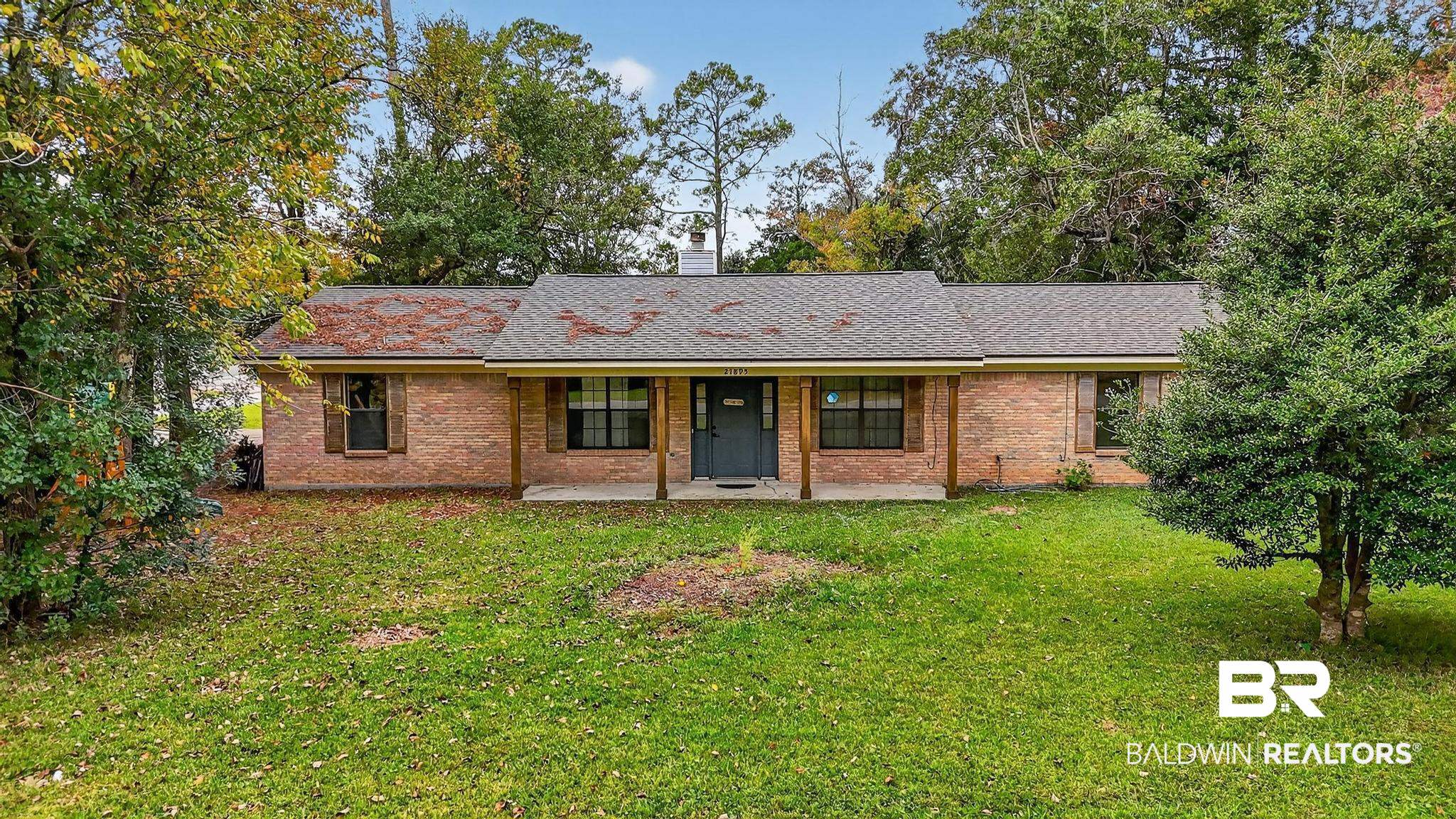 21895 2nd Street Silverhill, AL 36576 - Photo 2 of 43 Single story home with roof with shingles, covered porch, brick siding, and a front lawn