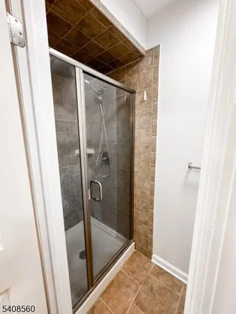 a bathroom with a glass door shower