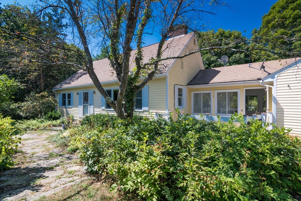 a front view of a house with a garden