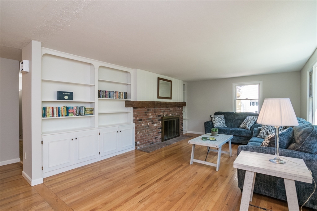 45 Cave Hill Road Leverett, MA 01054 - Photo 18 of 42 a living room with furniture a fireplace a lamp and a window
