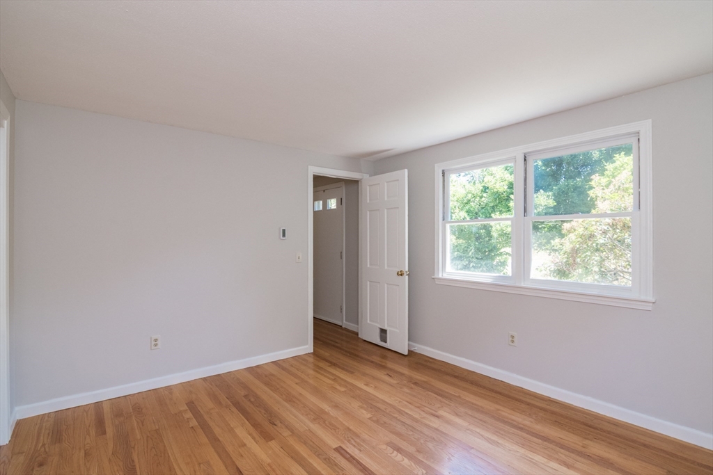 45 Cave Hill Road Leverett, MA 01054 - Photo 19 of 42 an empty room with wooden floor and windows