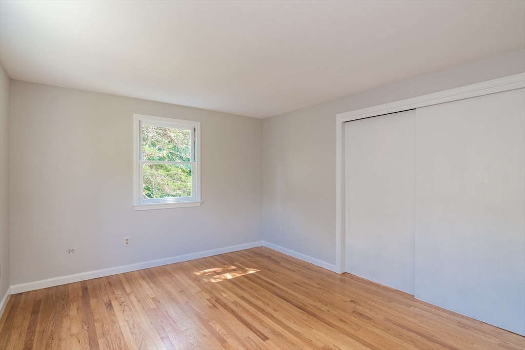 45 Cave Hill Road Leverett, MA 01054 - Photo 20 of 42 a view of an empty room with wooden floor and a window