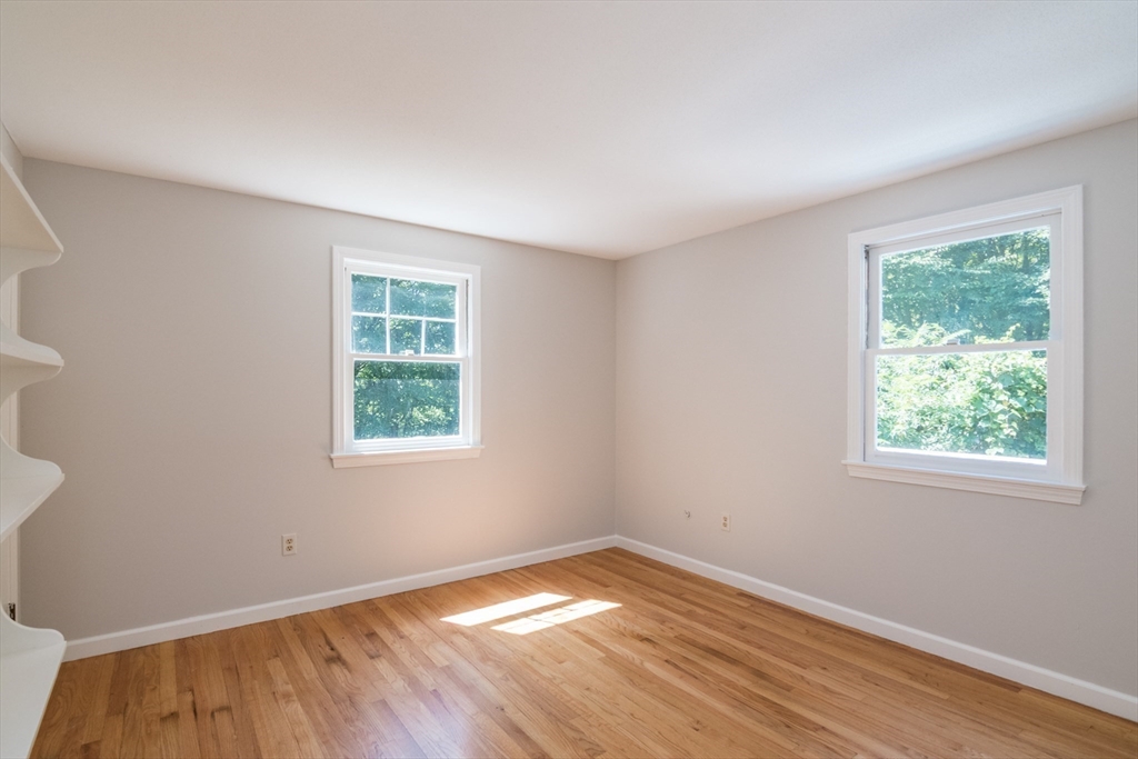 45 Cave Hill Road Leverett, MA 01054 - Photo 22 of 42 an empty room with wooden floor and windows