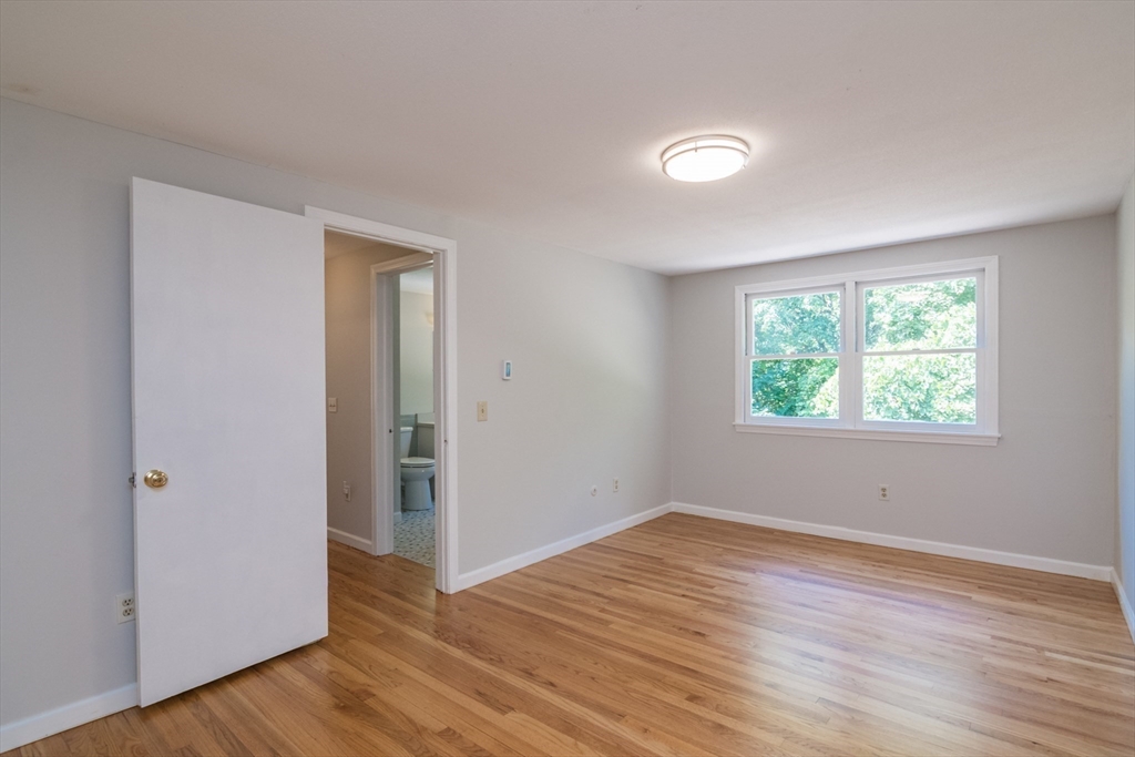 45 Cave Hill Road Leverett, MA 01054 - Photo 28 of 42 an empty room with wooden floor and windows